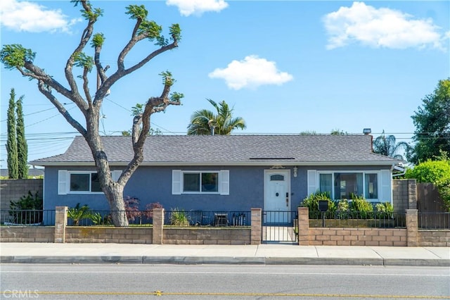 4865 Orchard St, Montclair, CA 91763 - view of front of home with stucco siding, a fenced front yard, roof with shingles, and a gate