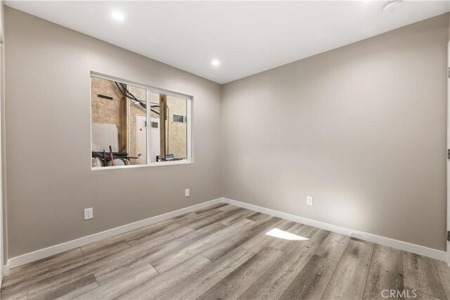 13250 Mercer St, Pacoima, CA 91331 - spare room featuring wood finished floors, baseboards, and recessed lighting