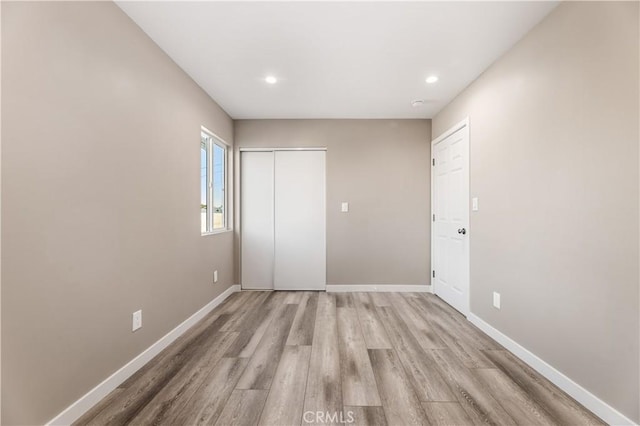 13250 Mercer St, Pacoima, CA 91331 - unfurnished bedroom featuring baseboards, light wood-style flooring, a closet, and recessed lighting