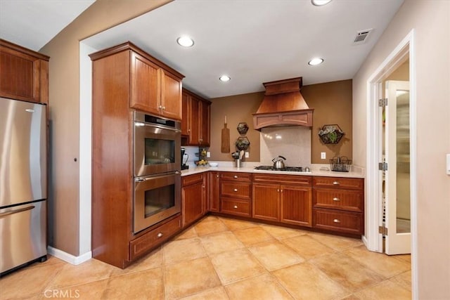 5498 Forked Horn Pl, Paso Robles, CA 93446 - kitchen featuring stainless steel appliances, custom exhaust hood, light countertops, brown cabinetry, and recessed lighting