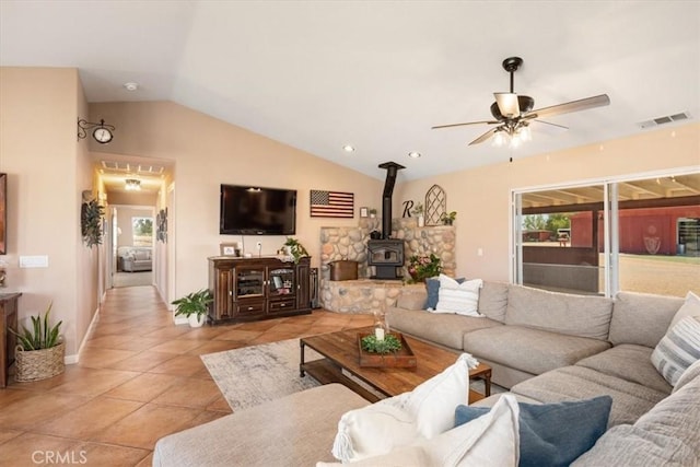 5498 Forked Horn Pl, Paso Robles, CA 93446 - living room featuring lofted ceiling, a wood stove, ceiling fan, light tile patterned flooring, and baseboards