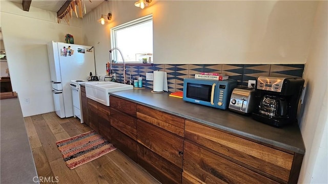 1240 Geronimo Trl, Yucca Valley, CA 92284 - kitchen with a sink, hardwood / wood-style flooring, freestanding refrigerator, and tasteful backsplash