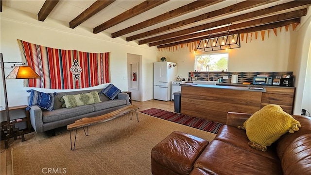 1240 Geronimo Trl, Yucca Valley, CA 92284 - living area featuring beamed ceiling, light wood-type flooring, and a chandelier