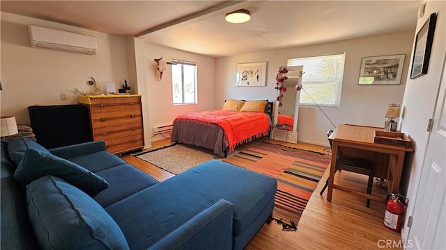 1240 Geronimo Trl, Yucca Valley, CA 92284 - bedroom with a wall mounted AC, baseboard heating, and wood finished floors