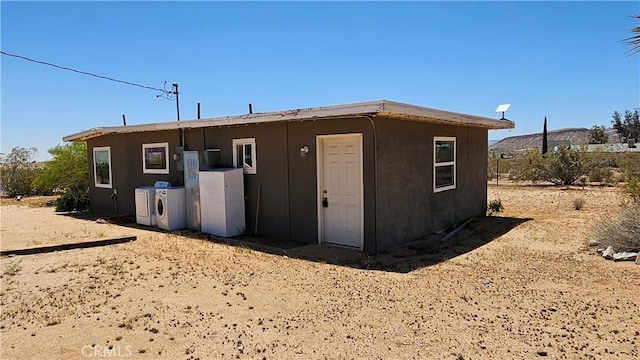 1240 Geronimo Trl, Yucca Valley, CA 92284 - back of house with washer and clothes dryer
