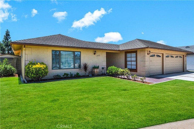 10924 Nighthawk Cir, Fountain Valley, CA 92708 - view of front of home with an attached garage, stucco siding, concrete driveway, and a front yard