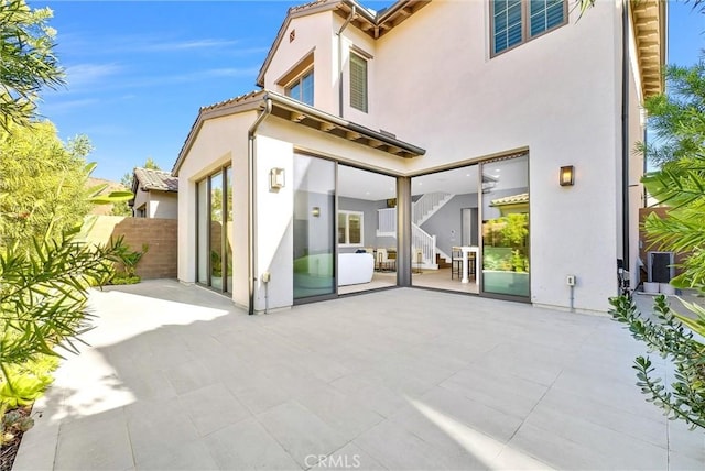 211 Fiore, Irvine, CA 92602 - rear view of property with a patio area, stucco siding, and stairs