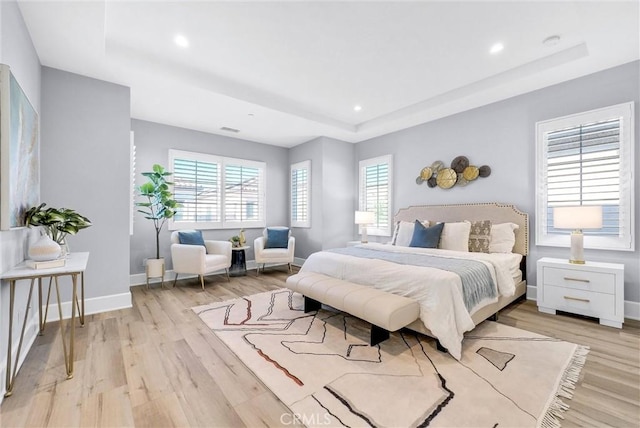 211 Fiore, Irvine, CA 92602 - bedroom featuring a tray ceiling, light wood-type flooring, baseboards, and recessed lighting