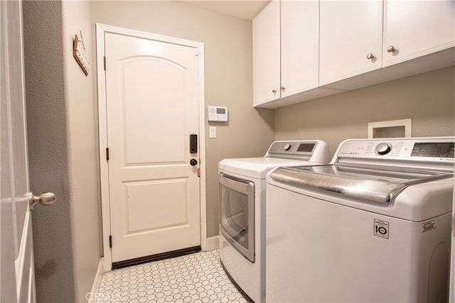 39883 S Creek Cir, Murrieta, CA 92563 - laundry room with washer and clothes dryer, cabinet space, light flooring, and baseboards