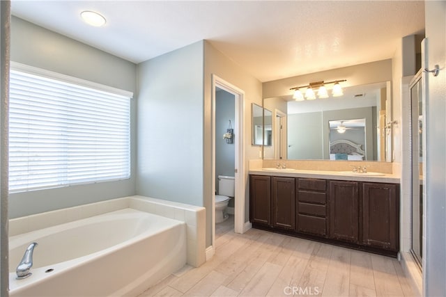 39883 S Creek Cir, Murrieta, CA 92563 - bathroom with a garden tub, toilet, wood finished floors, a stall shower, and double vanity