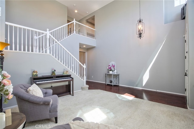 39883 S Creek Cir, Murrieta, CA 92563 - living area featuring carpet flooring, a towering ceiling, stairway, and baseboards
