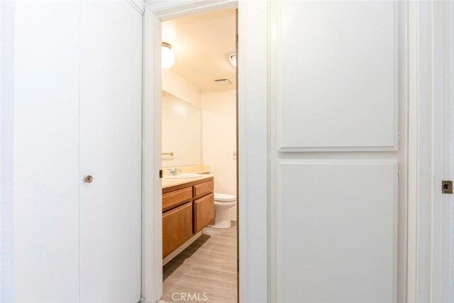 465 Ivy St Unit 203, Glendale, CA 91204 - bathroom featuring vanity, toilet, and wood finished floors