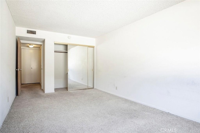 465 Ivy St Unit 203, Glendale, CA 91204 - unfurnished bedroom with light colored carpet, a closet, and a textured ceiling