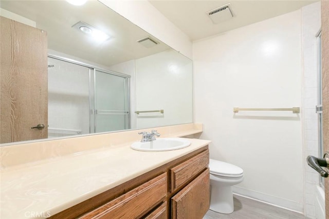 465 Ivy St Unit 203, Glendale, CA 91204 - bathroom with toilet, vanity, a shower with shower door, baseboards, and wood finished floors