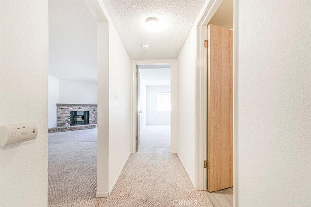 465 Ivy St Unit 203, Glendale, CA 91204 - hallway featuring light colored carpet, a textured ceiling, a textured wall, and baseboards