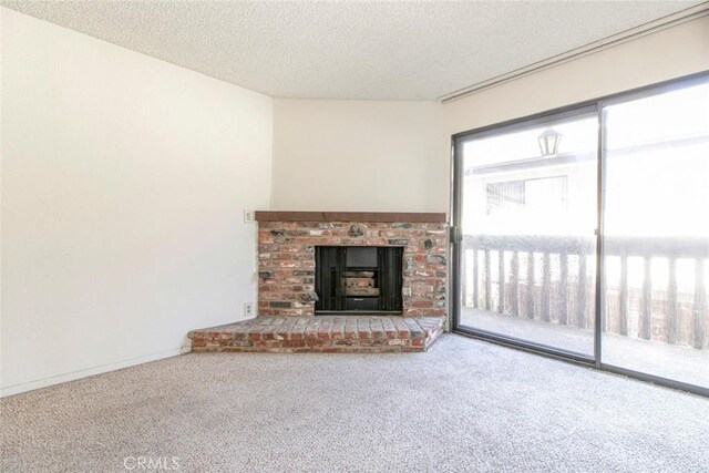 465 Ivy St Unit 203, Glendale, CA 91204 - unfurnished living room with carpet floors, a textured ceiling, and a fireplace