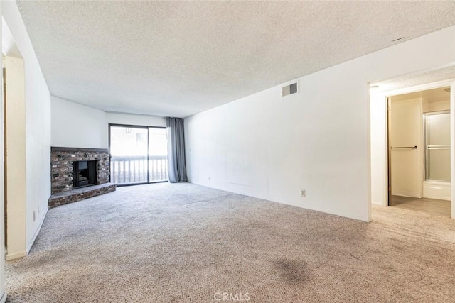 465 Ivy St Unit 203, Glendale, CA 91204 - unfurnished living room with carpet flooring, a textured ceiling, and a fireplace