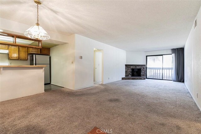 465 Ivy St Unit 203, Glendale, CA 91204 - unfurnished living room featuring a chandelier, carpet, a textured ceiling, and a fireplace