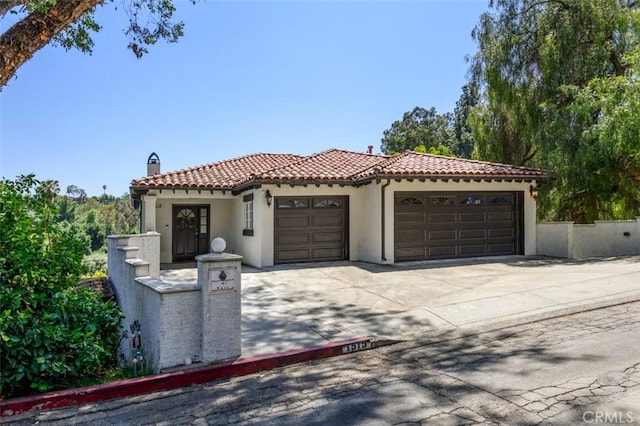 1515 Indiana Ave, South Pasadena, CA 91030 - mediterranean / spanish house featuring a chimney, stucco siding, a garage, a tile roof, and driveway