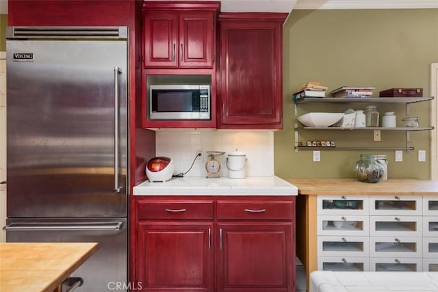 1515 Indiana Ave, South Pasadena, CA 91030 - kitchen with built in appliances, reddish brown cabinets, backsplash, and light countertops
