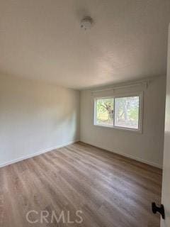 22425 Caminito Grande Unit 70, Laguna Hills, CA 92653 - empty room with wood finished floors and baseboards