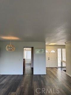 22425 Caminito Grande Unit 70, Laguna Hills, CA 92653 - unfurnished living room with wood finished floors and a chandelier