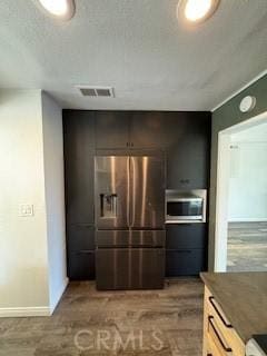 22425 Caminito Grande Unit 70, Laguna Hills, CA 92653 - kitchen featuring appliances with stainless steel finishes, baseboards, and carpet floors