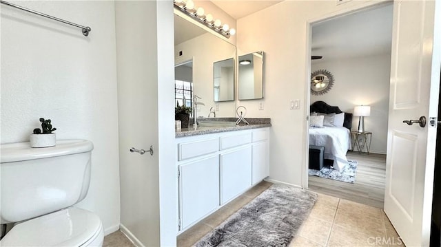2971 Plaza Del Amo Unit 243, Torrance, CA 90503 - bathroom with toilet, vanity, tile patterned floors, ensuite bath, and baseboards
