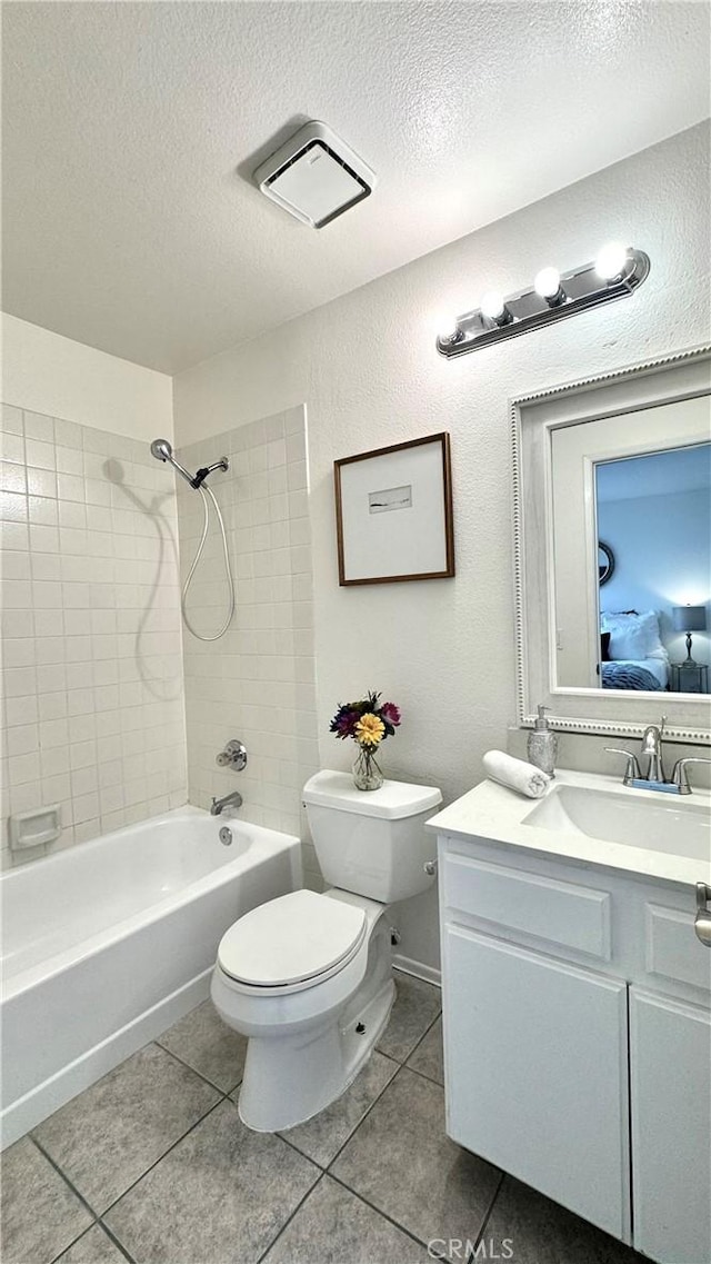 2971 Plaza Del Amo Unit 243, Torrance, CA 90503 - bathroom with tile patterned floors, toilet, vanity, tub / shower combination, and a textured ceiling