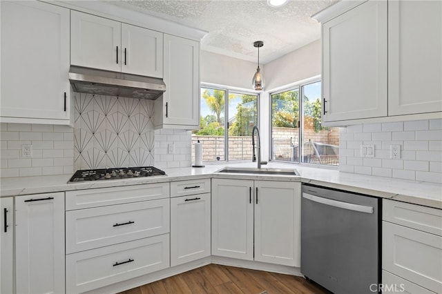 2251 Via Pacifica, Corona, CA 92882 - kitchen with stainless steel appliances, a sink, under cabinet range hood, a textured ceiling, and white cabinetry