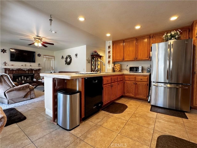 30027 Via Amante, Menifee, CA 92584 - kitchen with freestanding refrigerator, black dishwasher, a peninsula, tile counters, and open floor plan