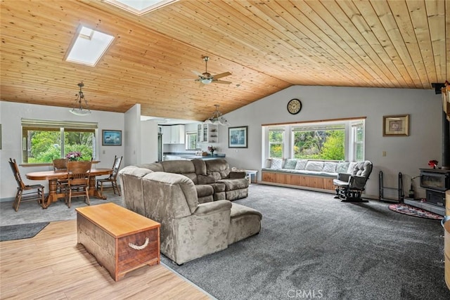 18520 Old Coast Hwy, Fort Bragg, CA 95437 - living room with a skylight, vaulted ceiling, a wood stove, wood ceiling, and healthy amount of natural light