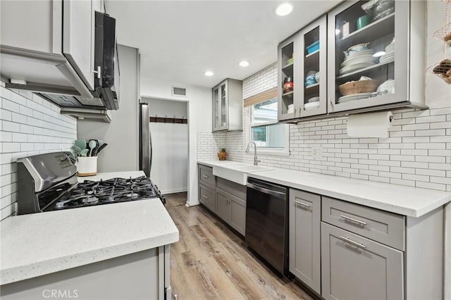 5226 Old Mill Rd, Riverside, CA 92504 - kitchen with dishwasher, range with gas stovetop, gray cabinets, a sink, and recessed lighting