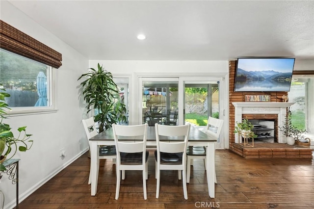 5226 Old Mill Rd, Riverside, CA 92504 - dining space featuring dark wood finished floors, a brick fireplace, baseboards, and recessed lighting