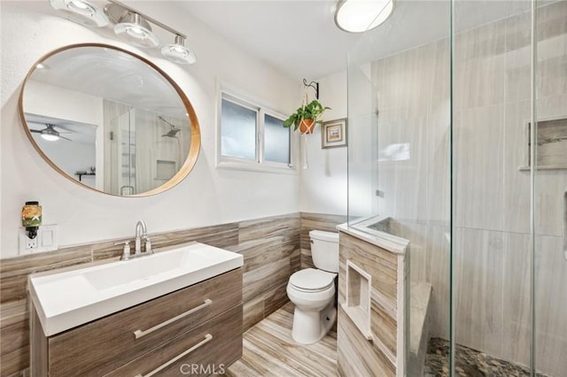 5226 Old Mill Rd, Riverside, CA 92504 - full bathroom featuring tile walls, toilet, vanity, a stall shower, and a ceiling fan