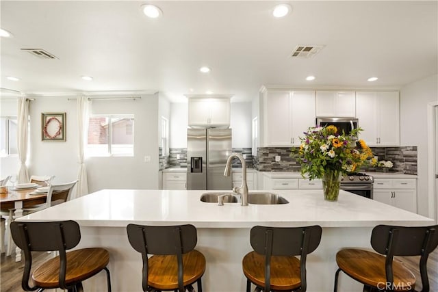 15952 Norcrest Dr, Whittier, CA 90604 - kitchen featuring stainless steel appliances, a sink, decorative backsplash, white cabinets, and recessed lighting