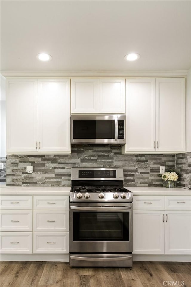 15952 Norcrest Dr, Whittier, CA 90604 - kitchen with stainless steel appliances, light countertops, white cabinets, and recessed lighting