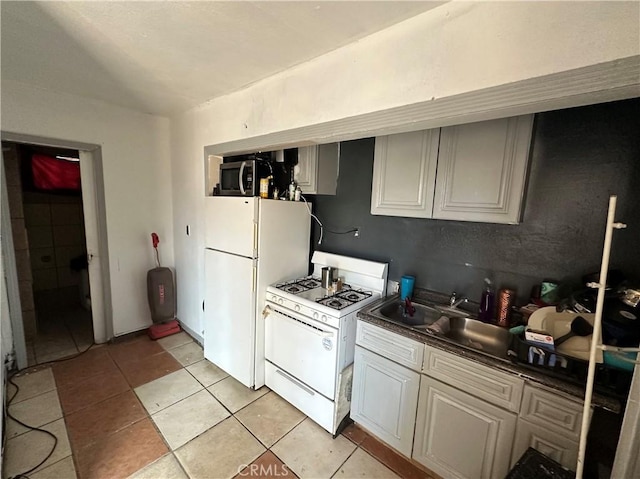 332 S Spring St, Blythe, CA 92225 - kitchen with white appliances, light tile patterned floors, and dark countertops