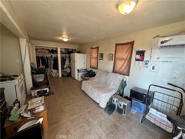 332 S Spring St, Blythe, CA 92225 - living area featuring a wall unit AC, a textured ceiling, and tile patterned flooring