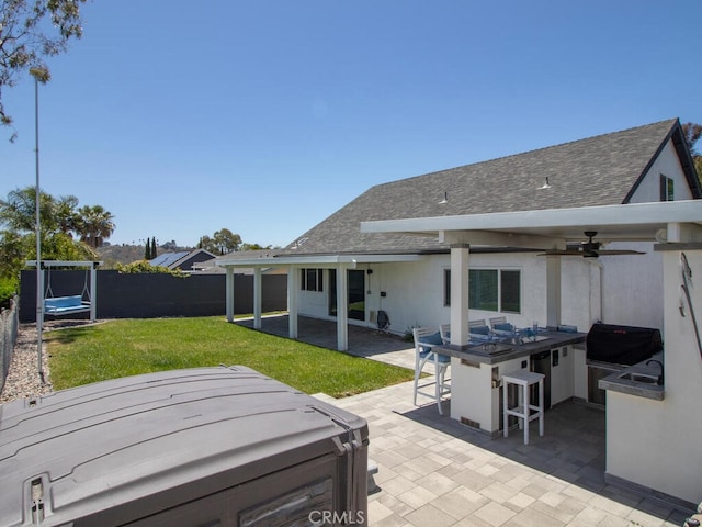 1914 Radford St, Oceanside, CA 92056 - rear view of property featuring a hot tub, roof with shingles, a ceiling fan, and a patio area