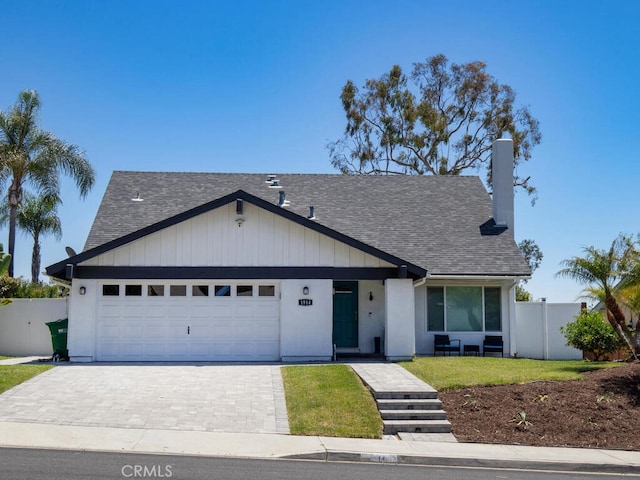 1914 Radford St, Oceanside, CA 92056 - view of front of house with roof with shingles, a garage, decorative driveway, and a chimney