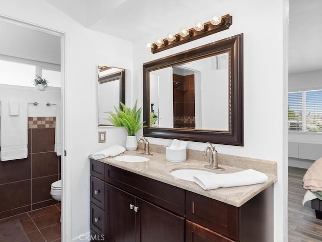1914 Radford St, Oceanside, CA 92056 - bathroom featuring toilet, double vanity, tile patterned floors, and tile walls