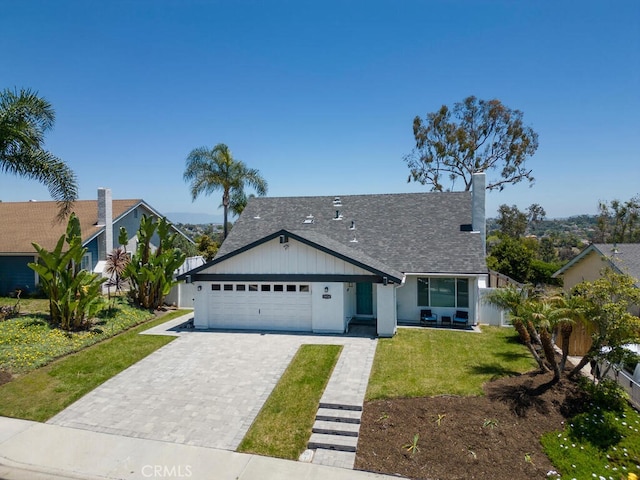 1914 Radford St, Oceanside, CA 92056 - view of front of home with an attached garage, a front yard, decorative driveway, a chimney, and roof with shingles