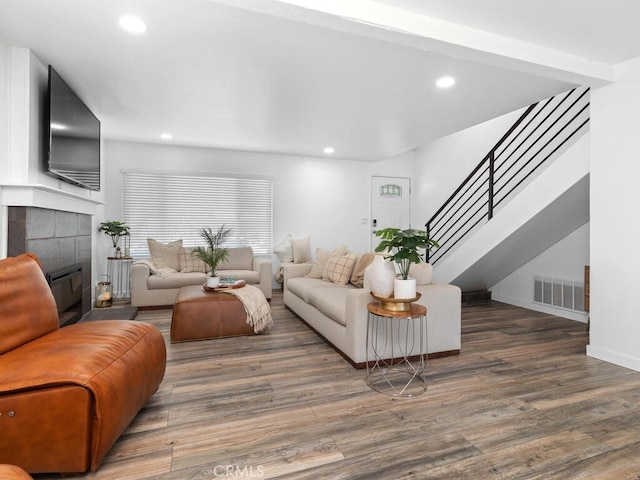 1914 Radford St, Oceanside, CA 92056 - living room with wood finished floors, recessed lighting, stairs, a tiled fireplace, and baseboards