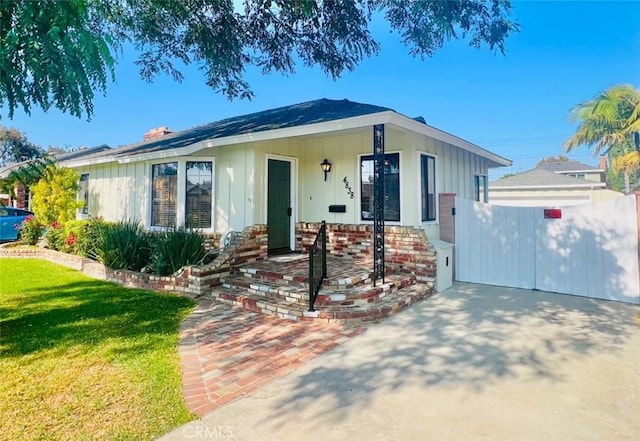 4838 Hazelbrook Ave, Long Beach, CA 90808 - view of front facade featuring board and batten siding and a front yard