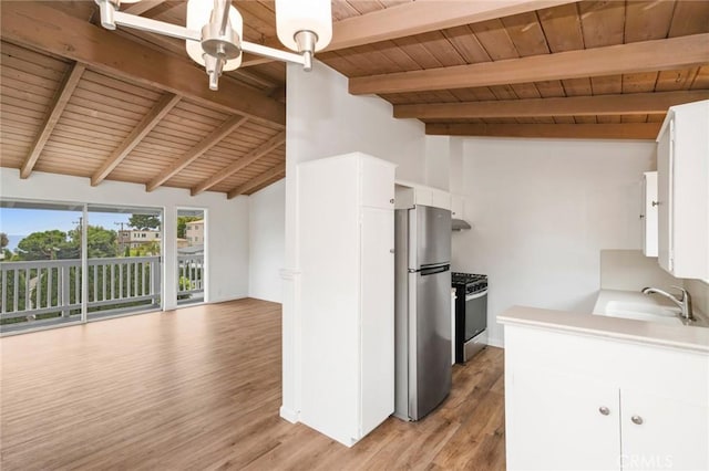 135 High Dr, Laguna Beach, CA 92651 - kitchen featuring a sink, gas range oven, freestanding refrigerator, wooden ceiling, and white cabinets