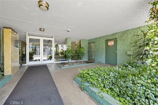 1187 E 3rd St Unit 104, Long Beach, CA 90802 - view of exterior entry featuring french doors and stucco siding