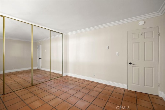 1187 E 3rd St Unit 104, Long Beach, CA 90802 - unfurnished bedroom featuring crown molding, tile patterned flooring, a closet, and baseboards