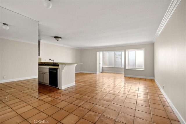 1187 E 3rd St Unit 104, Long Beach, CA 90802 - unfurnished living room with ornamental molding, light tile patterned floors, and baseboards