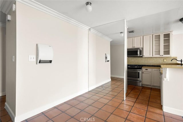 1187 E 3rd St Unit 104, Long Beach, CA 90802 - kitchen with stainless steel appliances, crown molding, decorative backsplash, light tile patterned floors, and glass insert cabinets